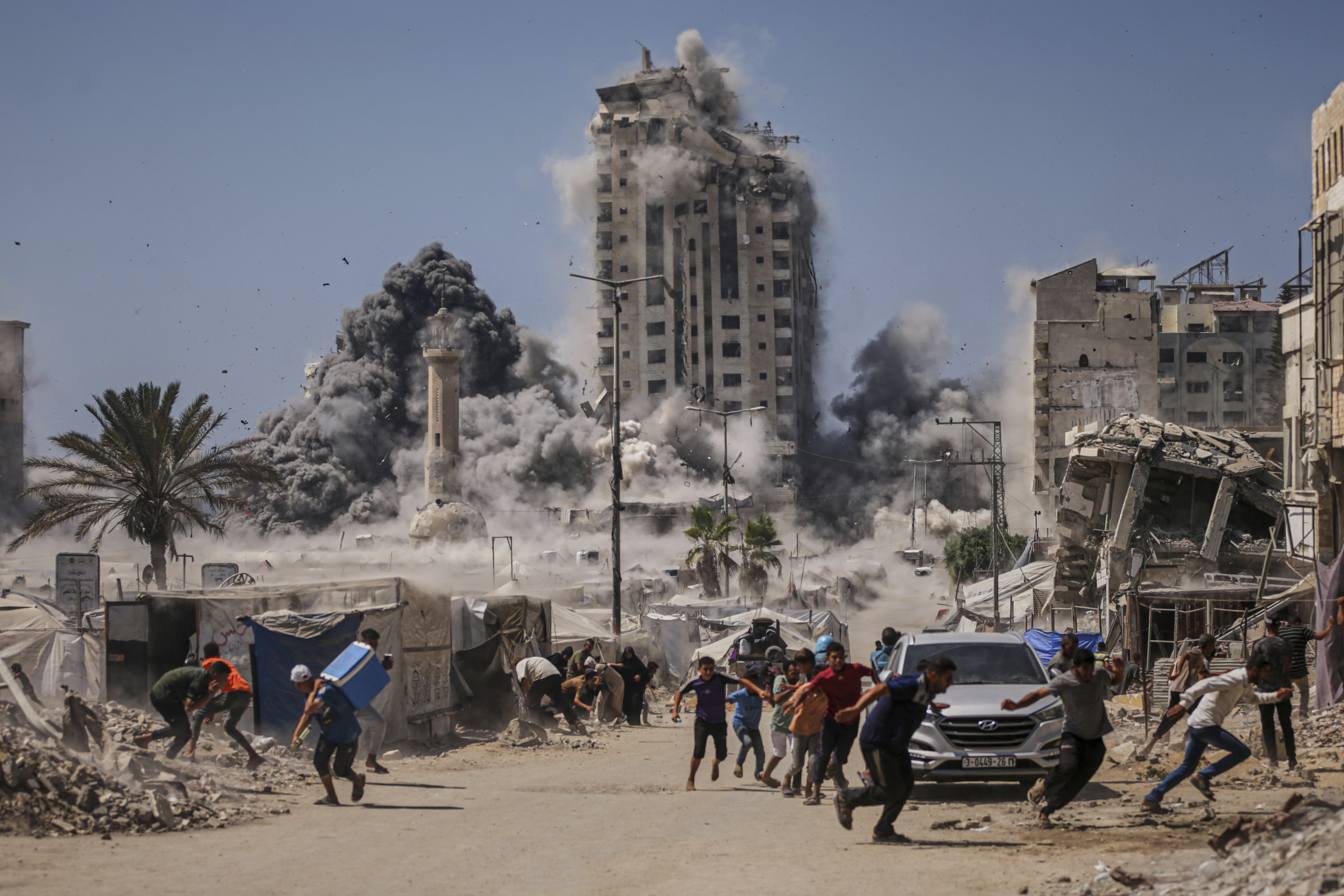  FILE - Palestinians run for cover during an Israeli airstrike on a high-rise building in Gaza City, Friday, Sept. 5, 2025, after the Israeli army issued a warning. (AP PhotoYousef Al Zanoun, File) 